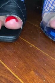 Watch – Red toenail claws in fishnets close up