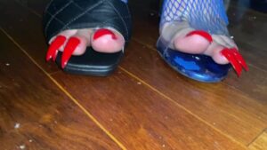 Watch – Red toenail claws in fishnets close up